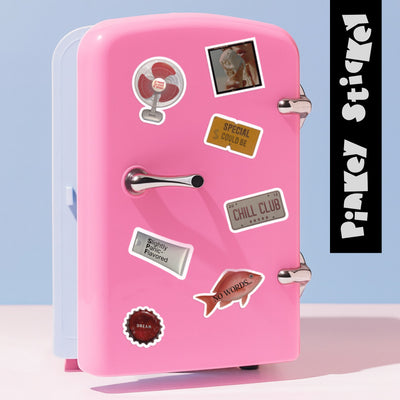 Pink mini refrigerator with various stickers on a light blue background