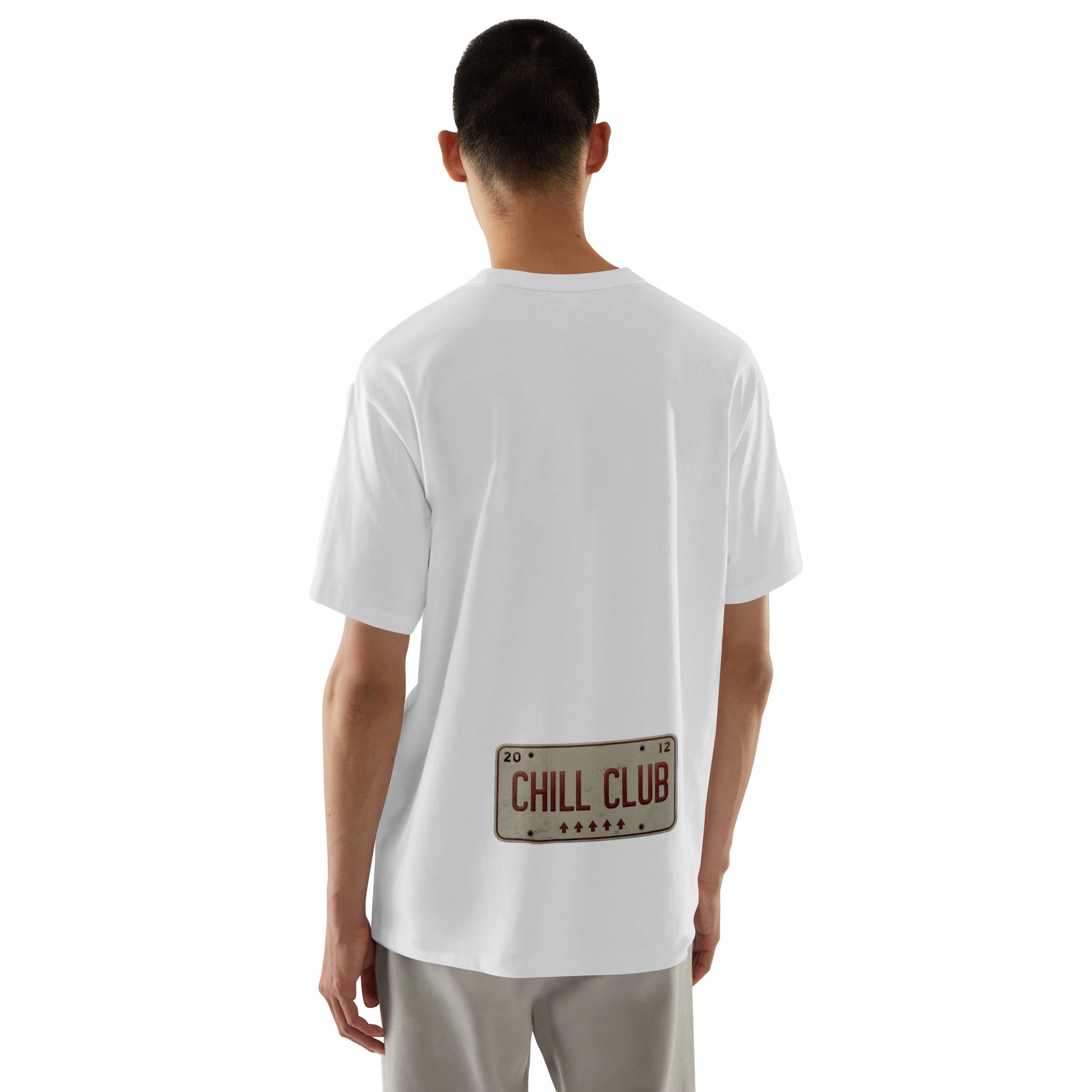 Person wearing a white t-shirt with 'Chill Club' text on the back, standing against a white background